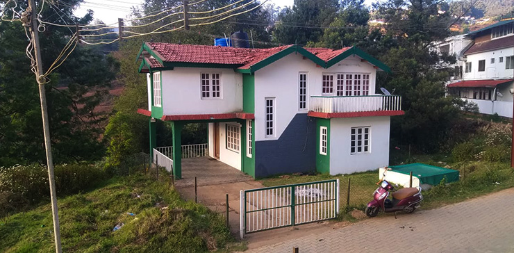 Exterior view showcasing the campfire area at Green Cottage