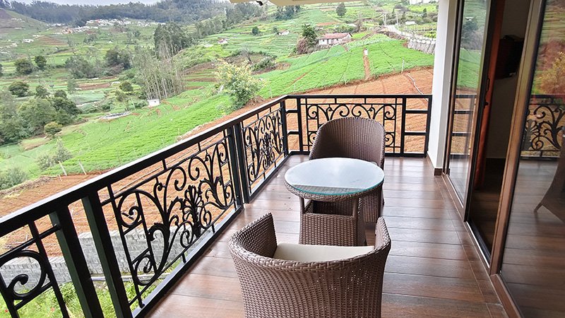 Aakran Cottage balcony top view with scenic valley