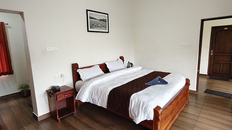Aakran Cottage spacious bedroom with wooden interiors