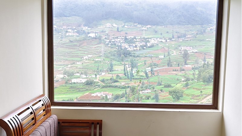 Aakran Cottage bedroom window with valley and hill view