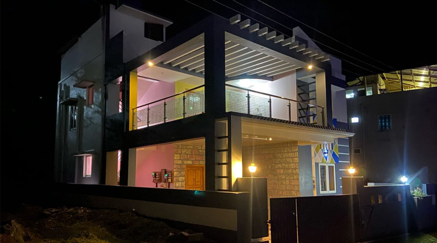 Exterior night view of a cottage with lights on