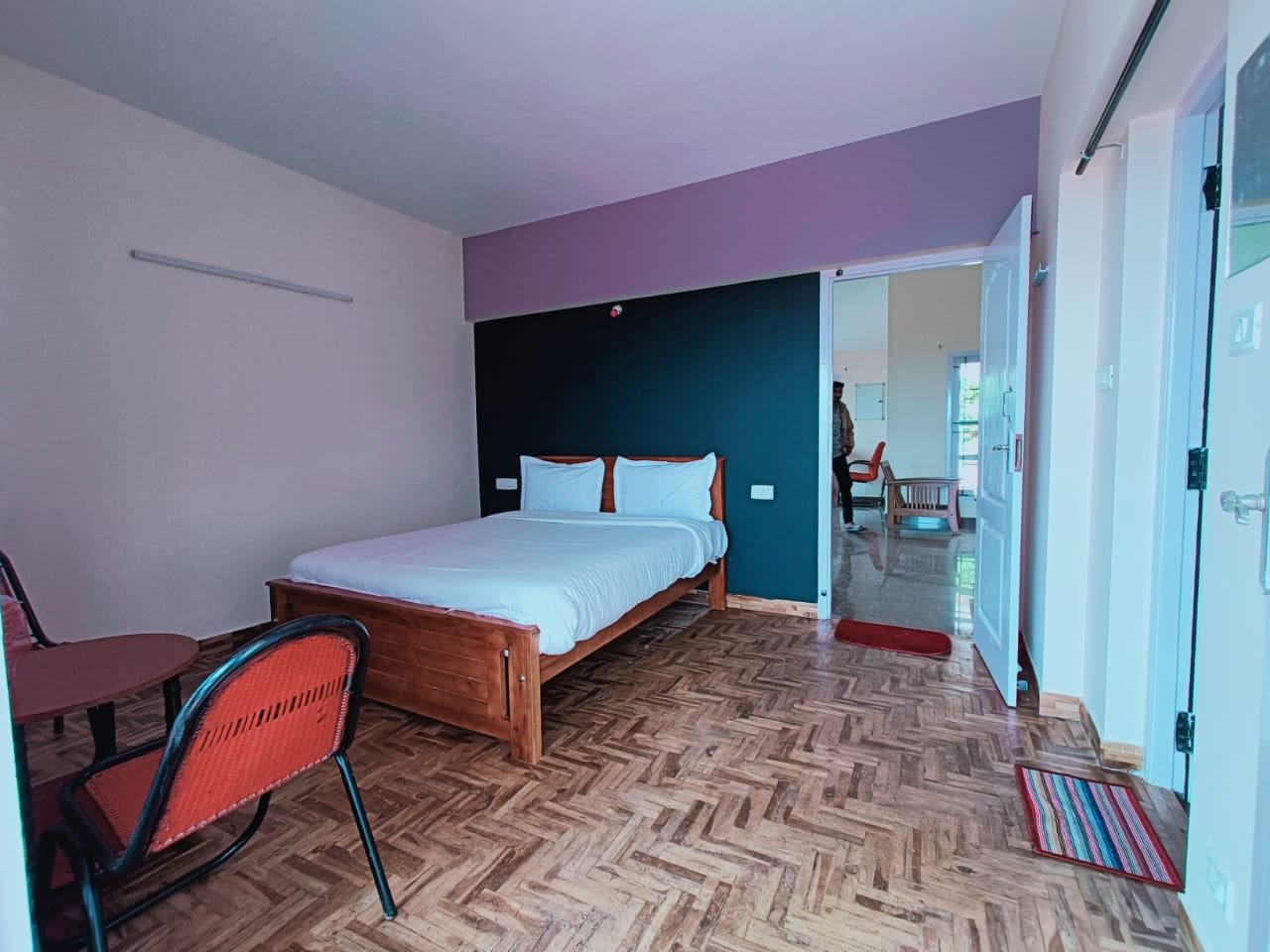 Spacious bedroom with wooden flooring and clean interiors