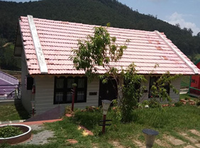 Cottage with red-tiled roof in a green hillside