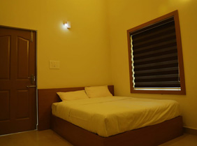 Cozy bedroom with a wooden bed, white bedding, and warm lighting