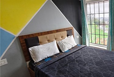 Budget bedroom with colorful geometric wall