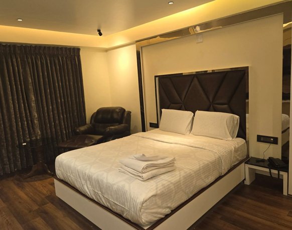 Premium hotel room with leather headboard and ambient lighting