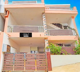 Modern guesthouse with balconies and gated entrance in Ooty