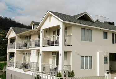 Modern accommodation with mountain backdrop