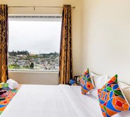 Bright room with colorful cushions and panoramic hill view