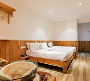 Cozy twin bedded room in Ooty with rustic wooden interiors