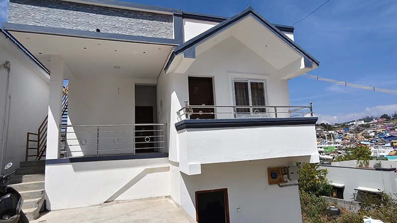 Mithra cottage exterior with balcony and stairs