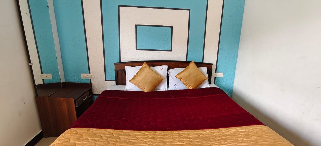 Bedroom with a double bed and turquoise patterned wall