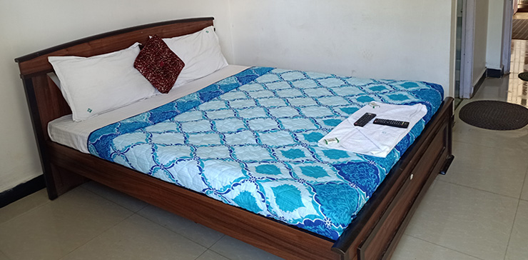 Wooden bed with blue bedding