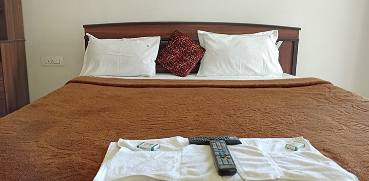 Close-up of bed with brown blanket