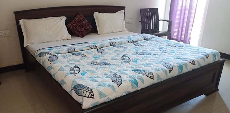 Bed with blue-patterned bedding