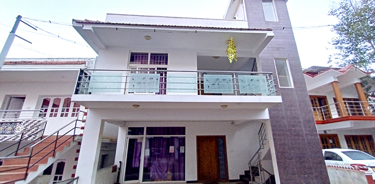 A modern two-story house with a balcony