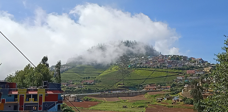 Green hills with mist and houses