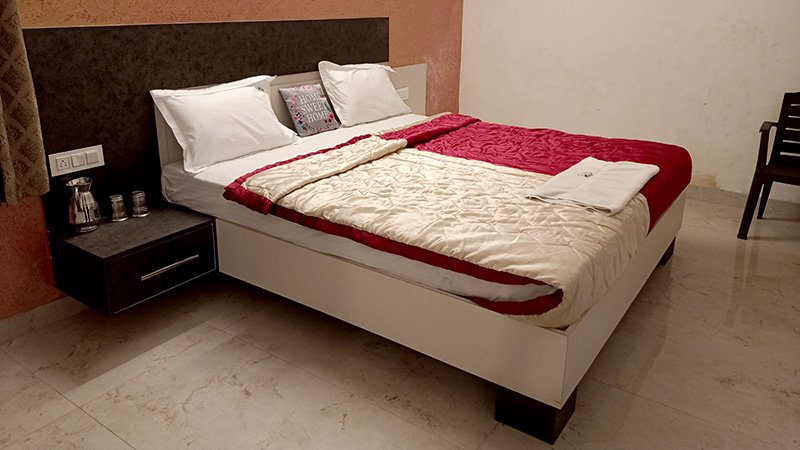 Bedroom with double bed and red blanket