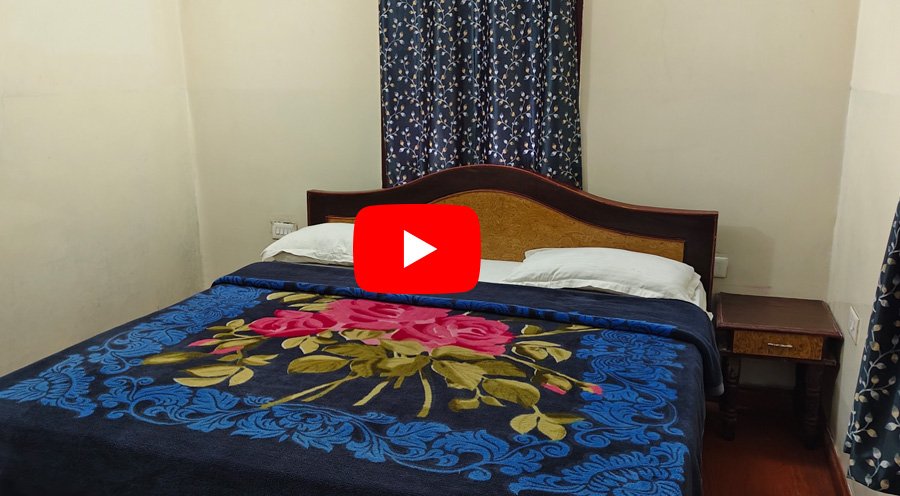 Cozy bedroom homestay with floral blanket and vintage headboard
